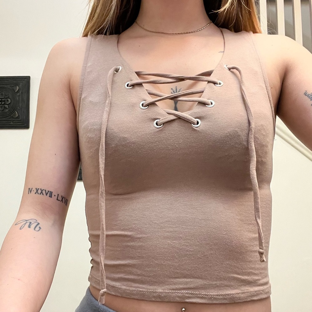 Tan cute crop top. Tank top with adjustable strings in front.